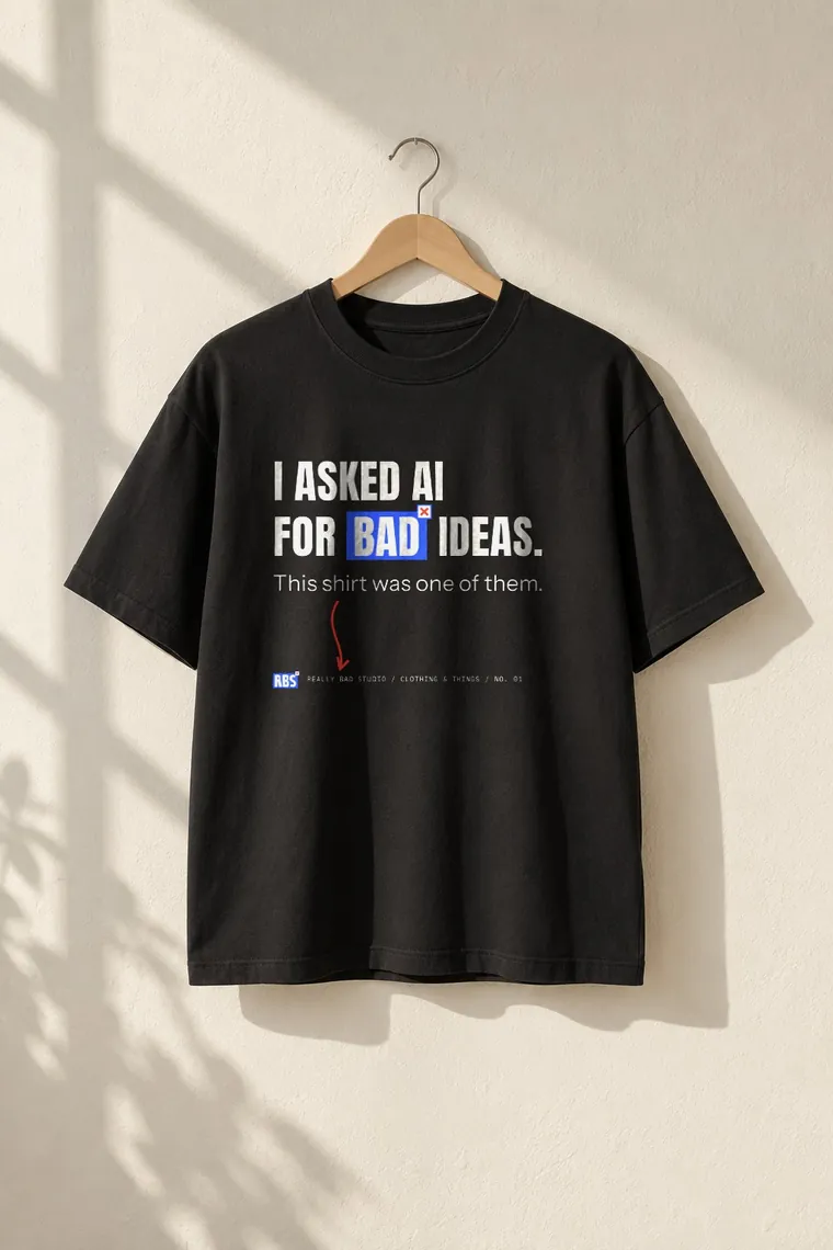 The bad ideas tee, black, on a wooden hanger.