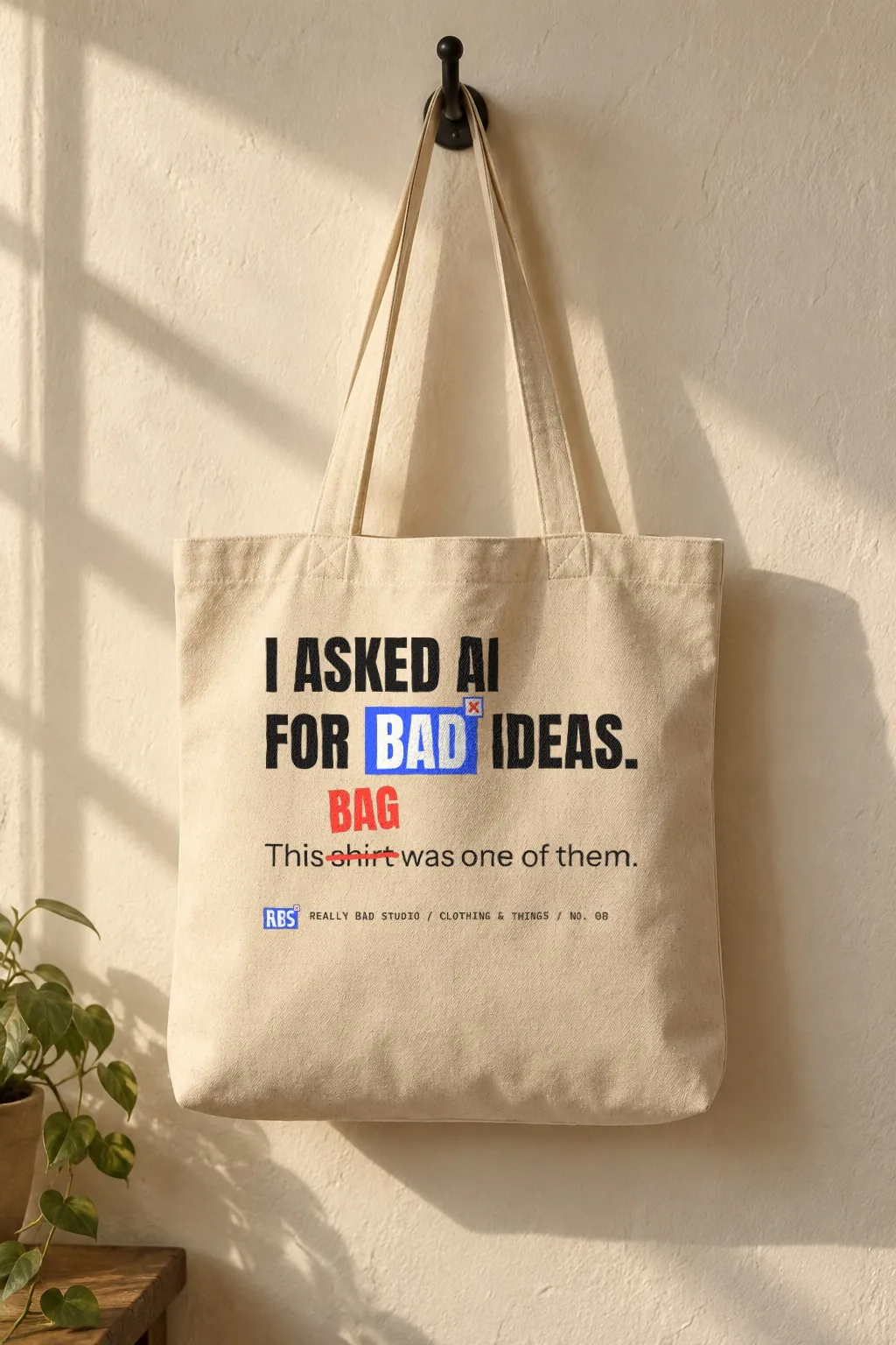 A canvas tote with the same joke, where the word shirt is crossed out in red and corrected to bag.